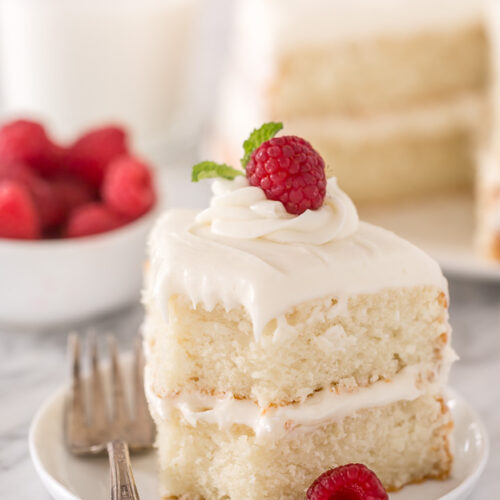 This is the BEST white cake recipe you'll ever bake! Each slice is moist, fluffy, and so delicious. This tender snow-white cake is made completely from scratch and with simple ingredients!